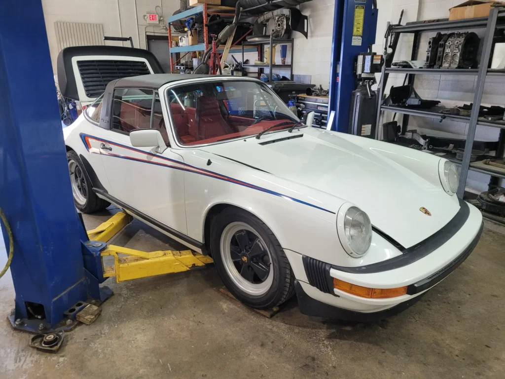 White Porsche 911 Targa on a lift at Alpine Autowerks
