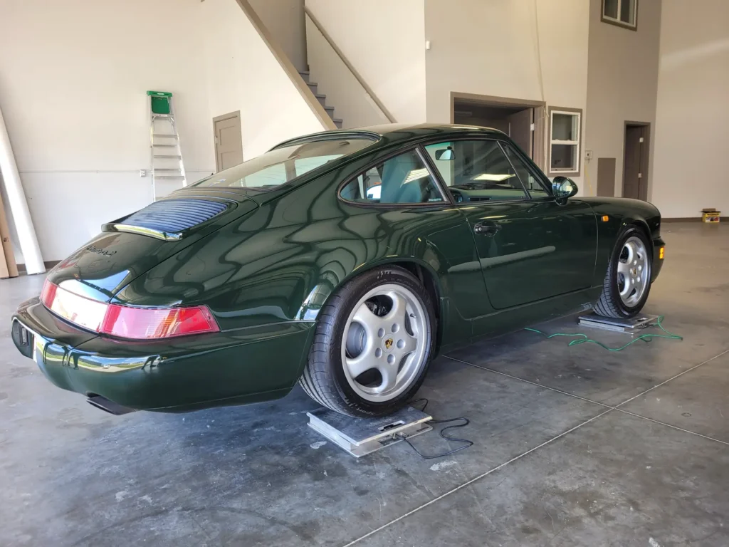 Green Porsche 964 on corner scales