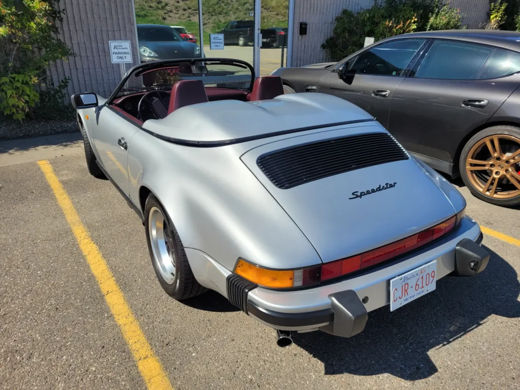Silver Porsche 911 Speedster parked outside the shop