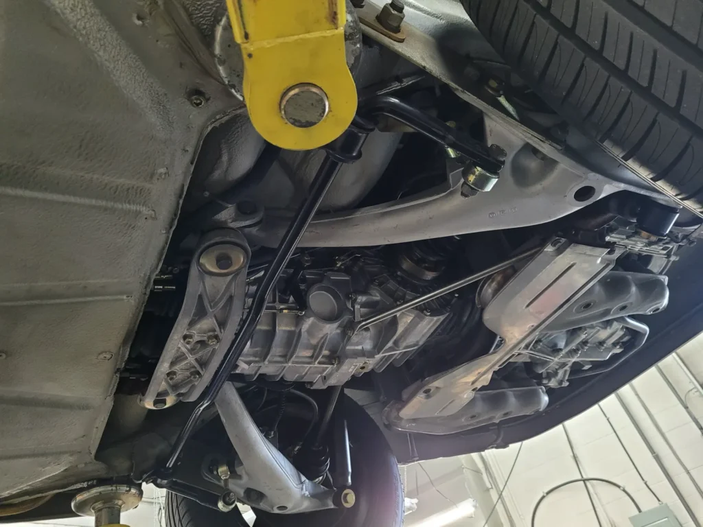 Underside of a car on the lift at Alpine Autowerks
