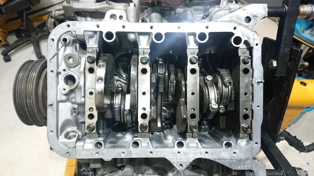 Bottom end of an engine with the crankshaft exposed during a rebuild