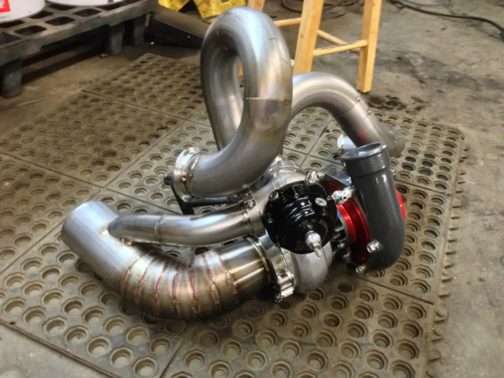 Turbocharger with fabricated piping on the floor at Alpine Autowerks