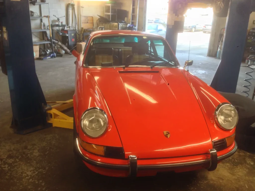 Orange Porsche 911 on a lift at Alpine Autowerks