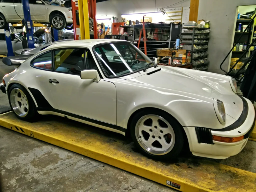 White Porsche 911 Turbo on a four-post lift