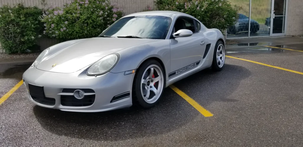 Silver Porsche Cayman S in a parking lot