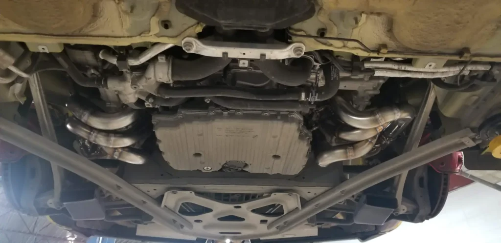 Underside of a Porsche on the lift during an inspection