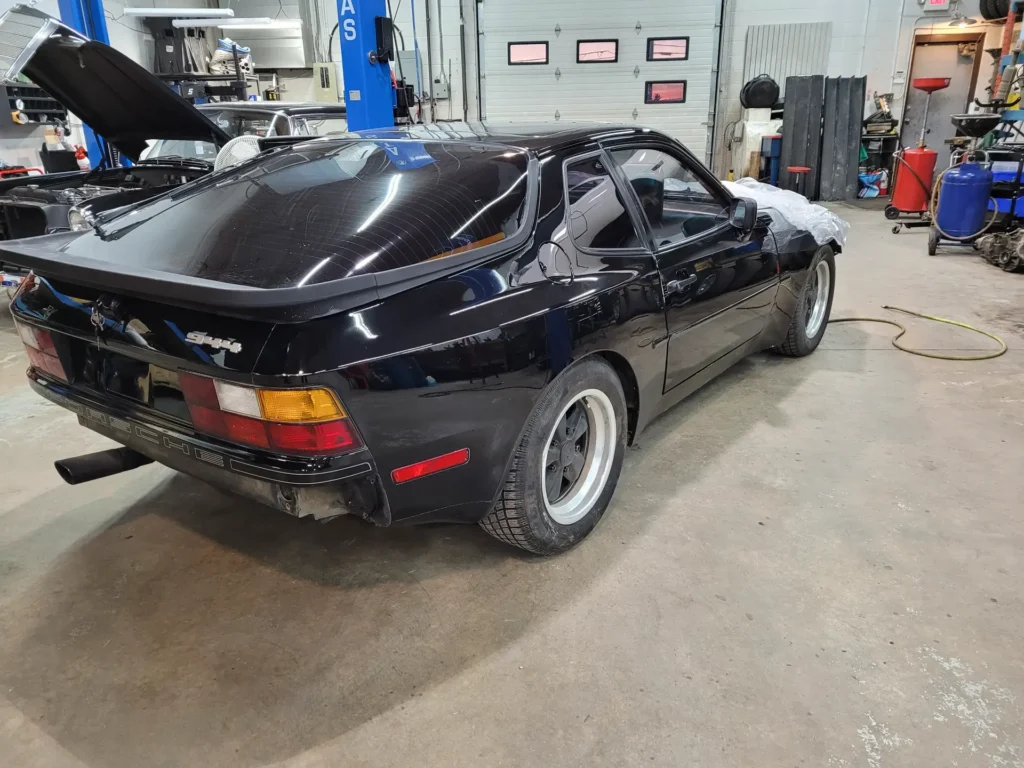 Black Porsche 944 in a service bay
